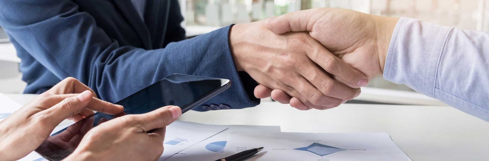 in raise business handshake of two men demonstrating their agreement to sign agreement or contract between their firms companies enterprises
