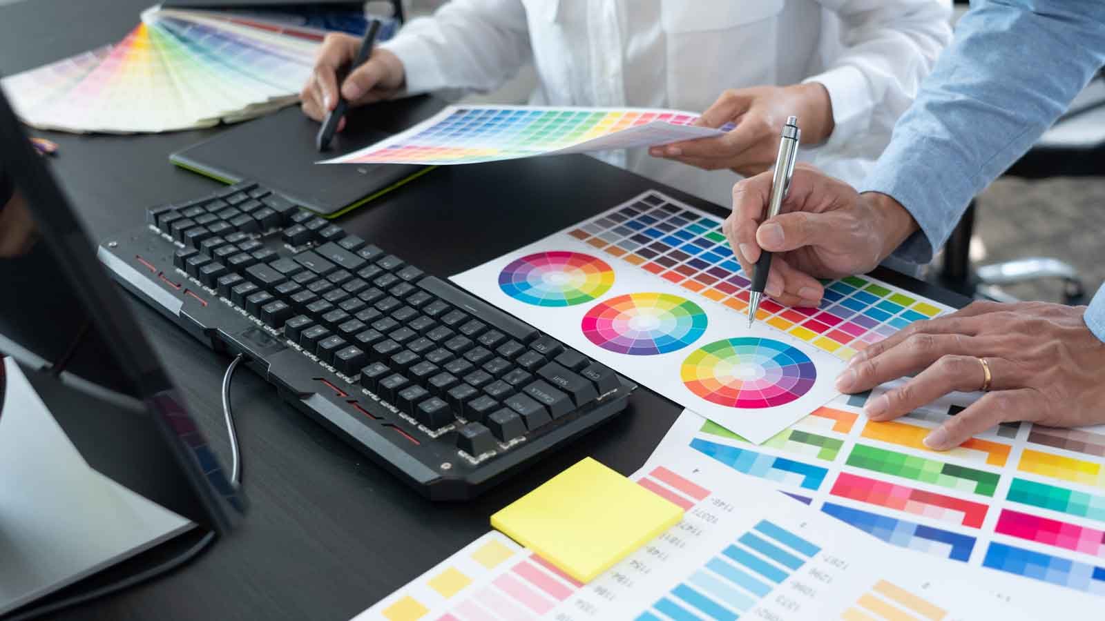 in raise design studio why you want a cugraphic designer team working web design using color swatches editing artwork using tablet stylus desks creative office